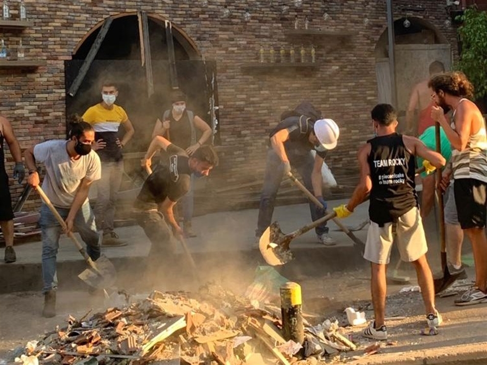 Volunteers clean the rubble in Mar Mikhael (Photo: Mona Fawaz) 